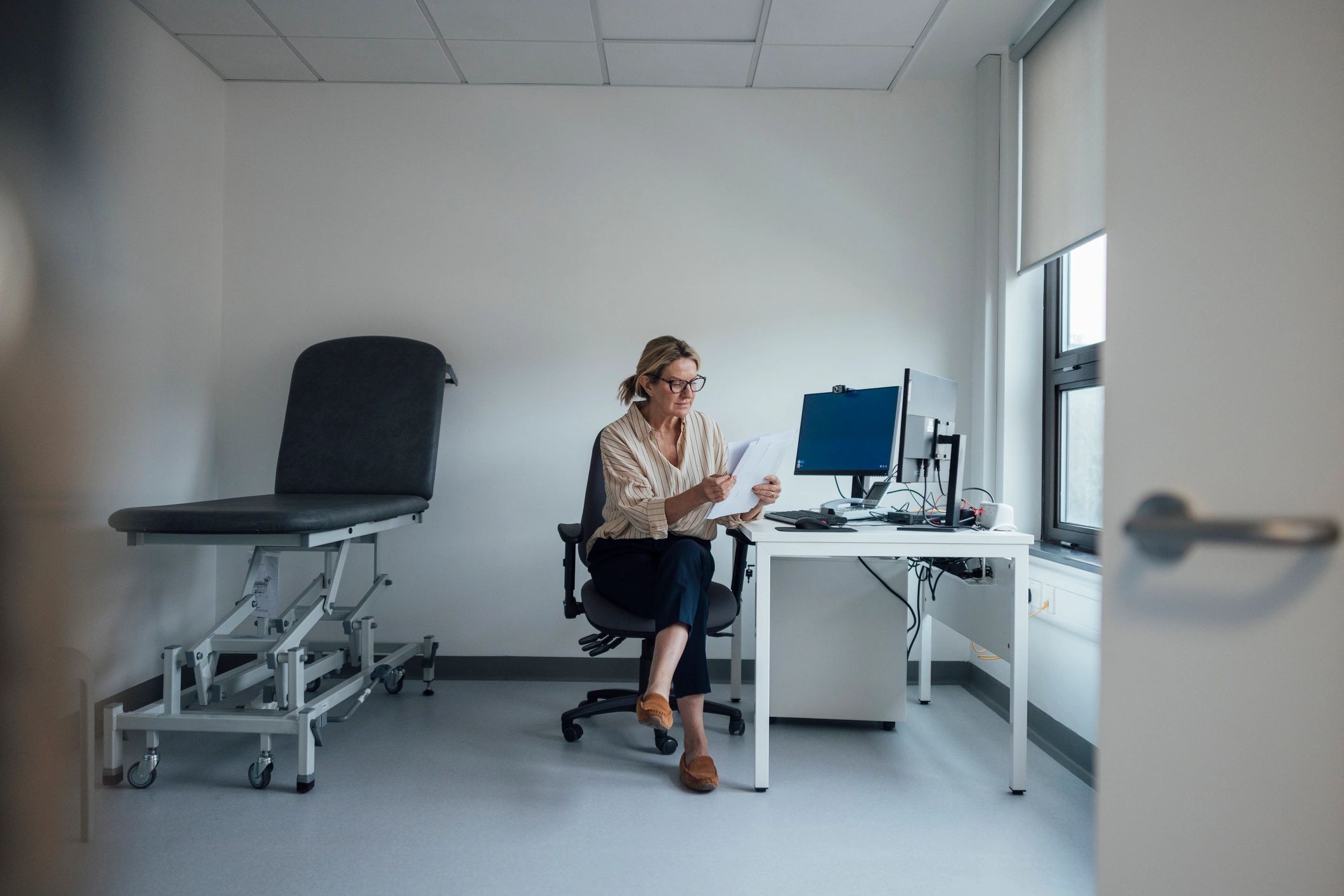 Healthcare professional reviewing documents at desk